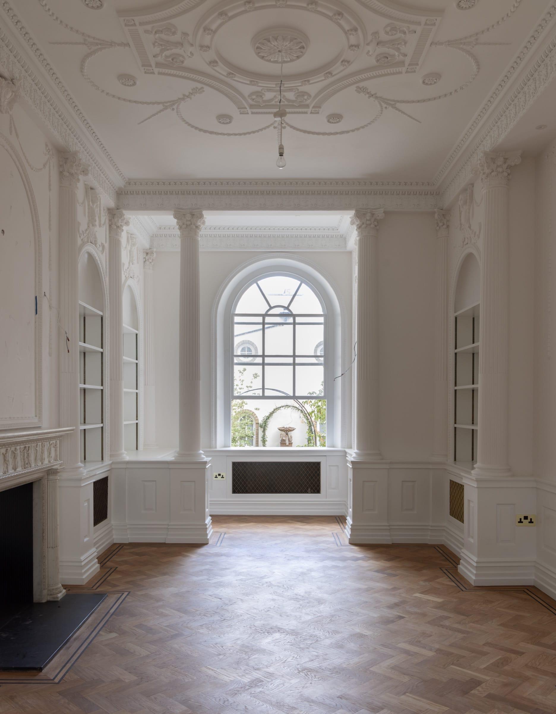 Drawing room with restored decorative plasterwork and an arched window to the garden — Chester Square, Belgravia SW1W