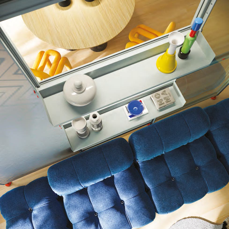 Visualisation: overhead view of glass shelving on a divider frame above a blue sofa