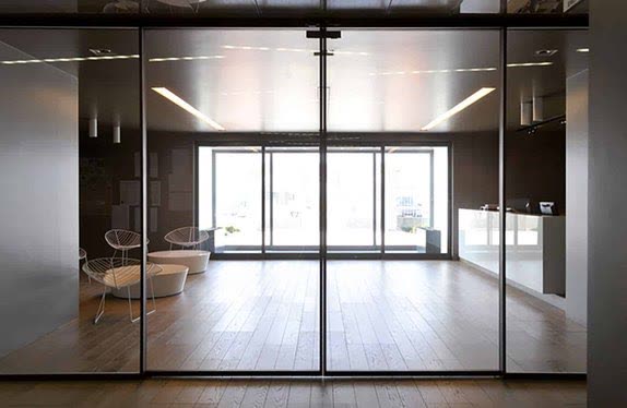 Full-height glazed entrance screen into a timber-floored lobby