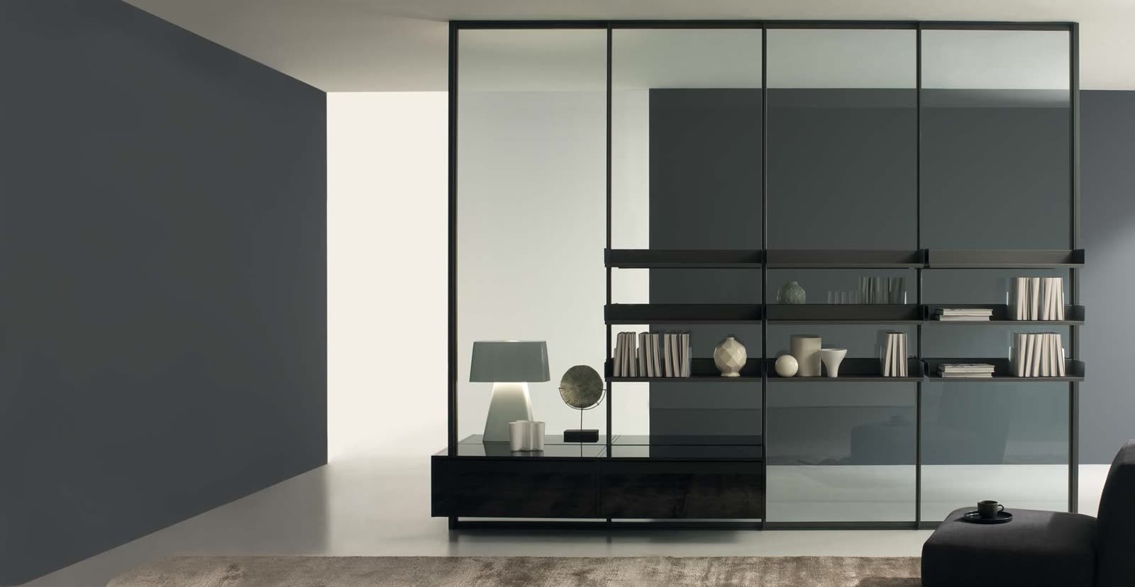 Shelving and a low sideboard hung from the uprights of a glass wall