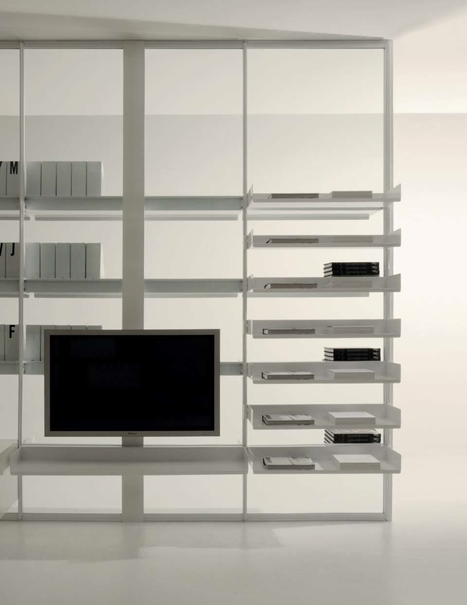 Wall of shelves with a television mounted on partition uprights