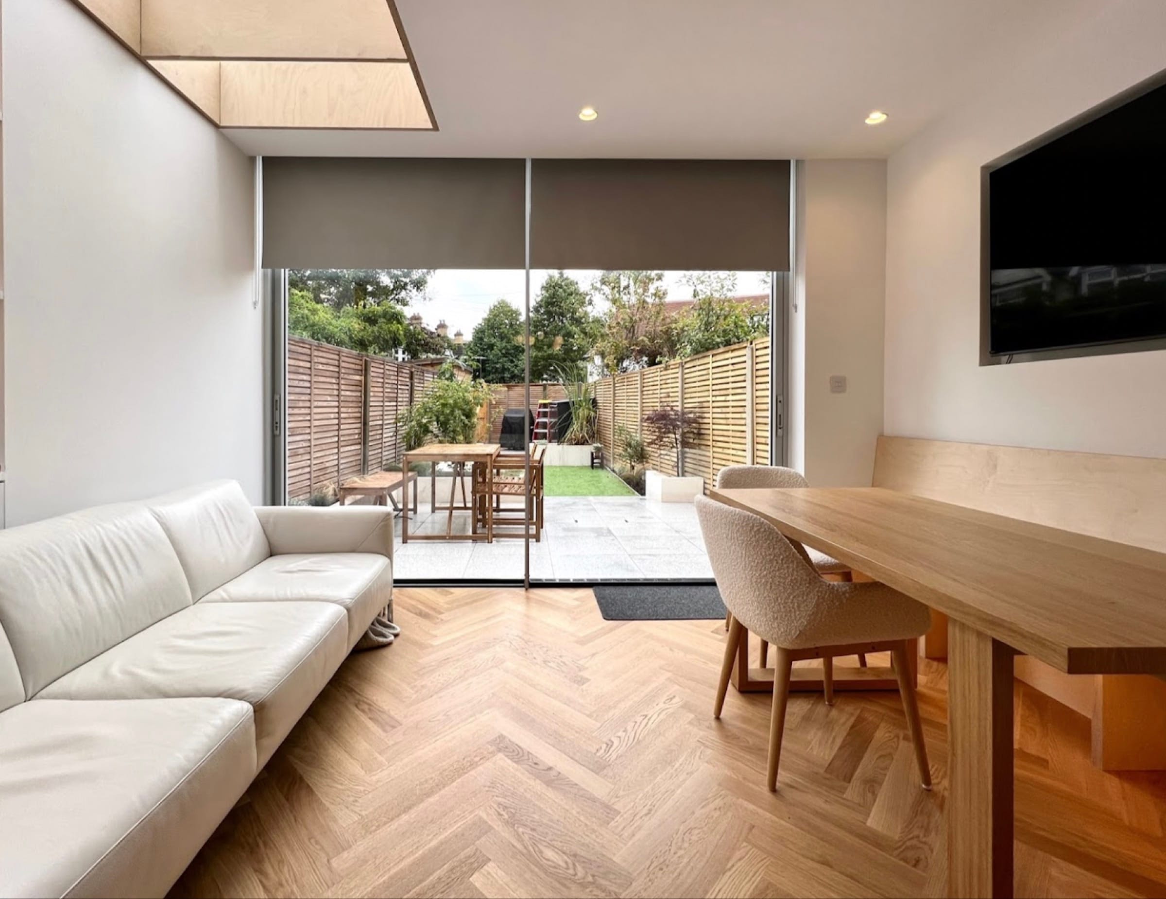 Rear extension living and dining space with full-width sliding doors to the patio — the garden wall a glazing budget is spent on