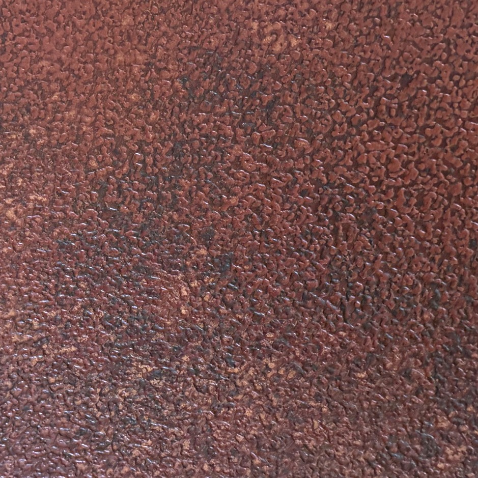Close-up of a rust-red metallic resin panel, rust activated and then neutralised