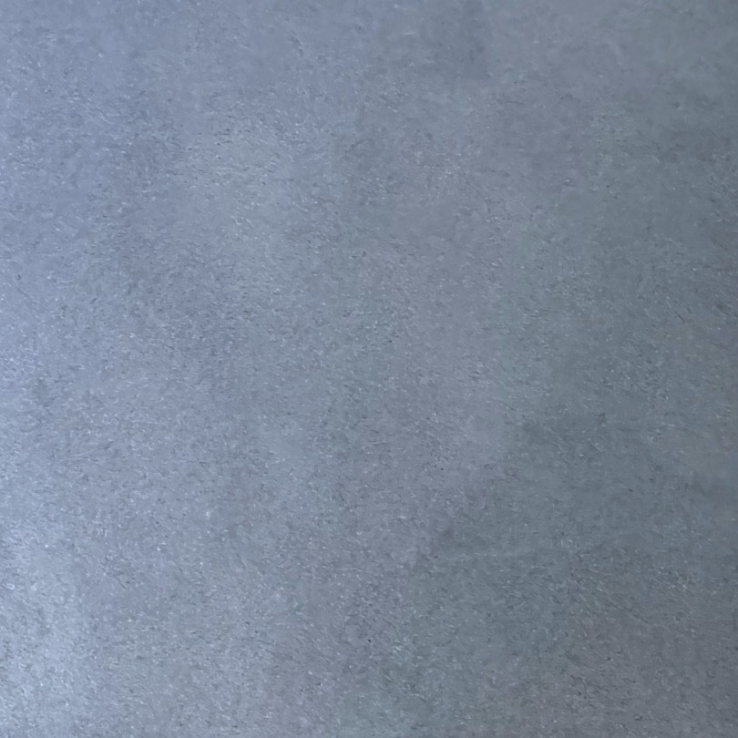 Close-up of a blue-grey resin sample board with clouded, mottled movement