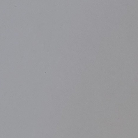 Close-up of an even mid-grey resin sample board, flat and matt