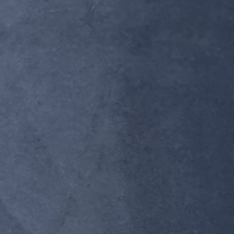Close-up of a deep navy resin sample board with subtle darker patches