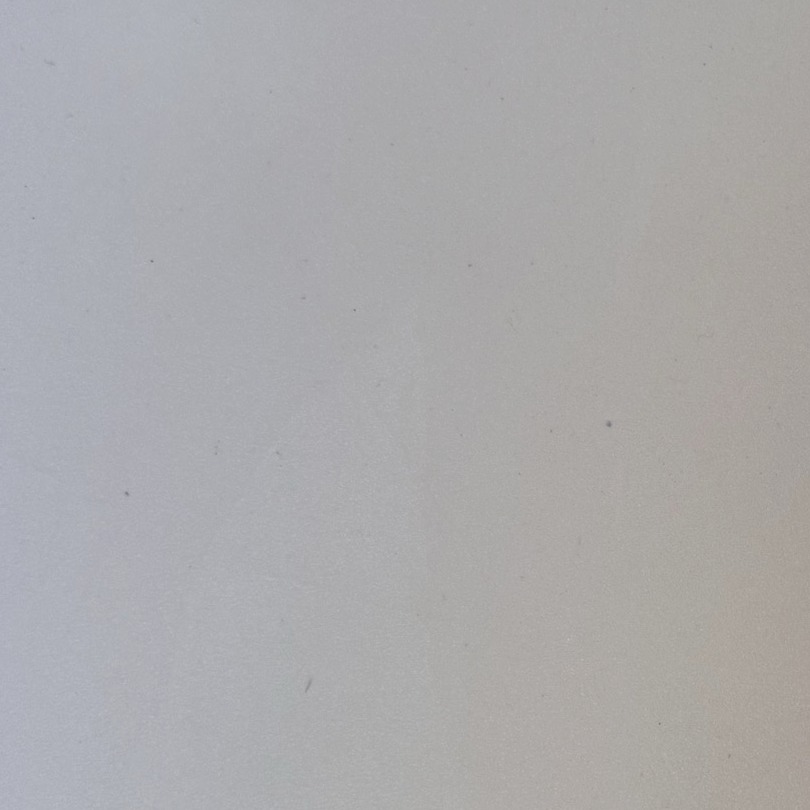 Close-up of a smooth pale grey resin sample board with almost no trowel movement