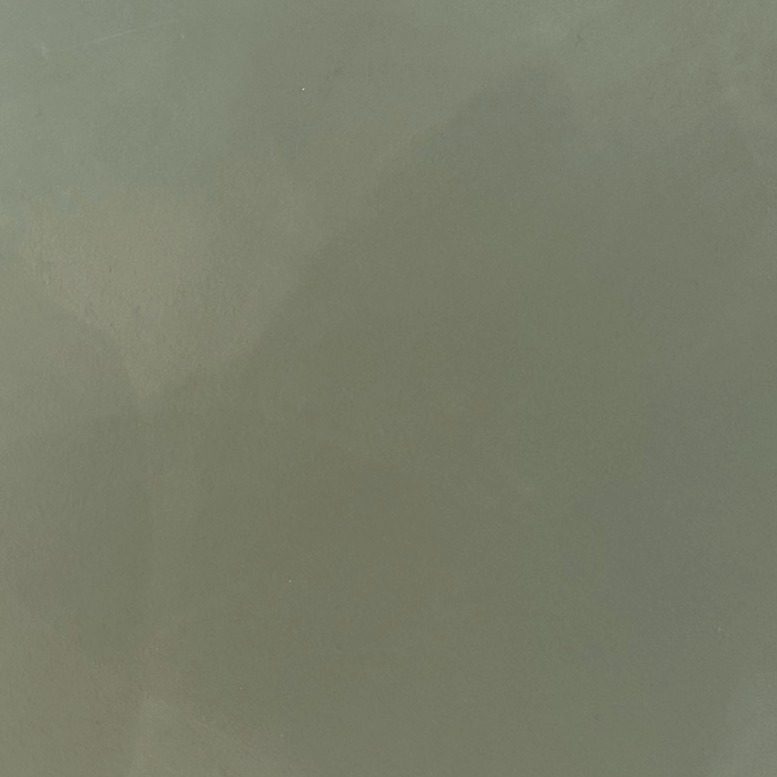 Close-up of a muted sage green resin sample board with light shading